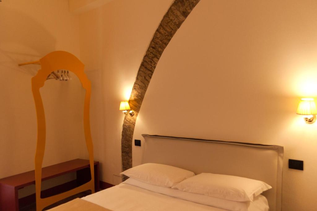 Postel nebo postele na pokoji v ubytování Palazzo Benucci