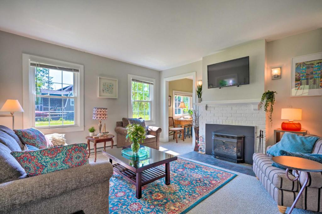 a living room with a couch and a fireplace at Lovely Lakewood Cottage Near Chautauqua Lake! in Lakewood