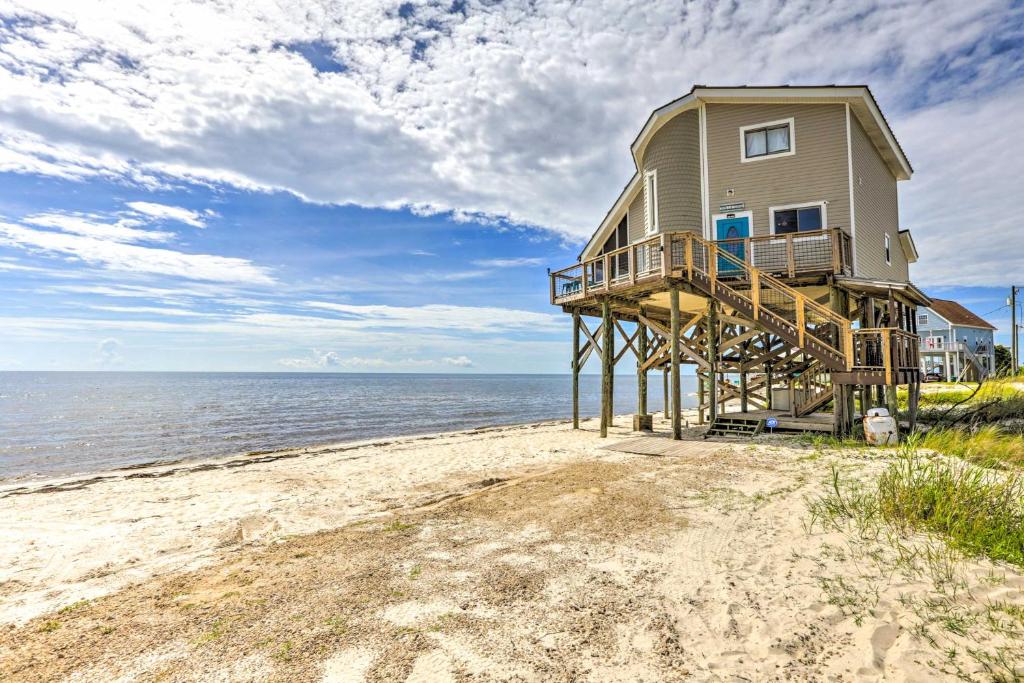 a house on the beach next to the ocean at Secluded Beachfront Gem on Alligator Point! in Sun N Sand Beaches