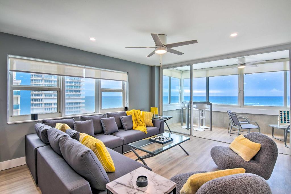 a living room with a couch and chairs and windows at Oceanfront Luxury 2and2 Condo with Amazing Views! in Fort Lauderdale