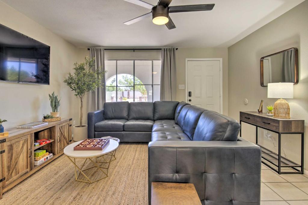a living room with a leather couch and a table at Pet-Friendly Peoria Home Patio, Grill and Foosball! in Peoria