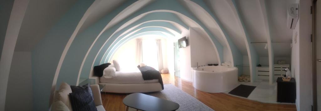 uma casa de banho com um tecto arqueado e uma banheira branca em ESPEJO DE SOLEDADES em Vigo de Sanabria