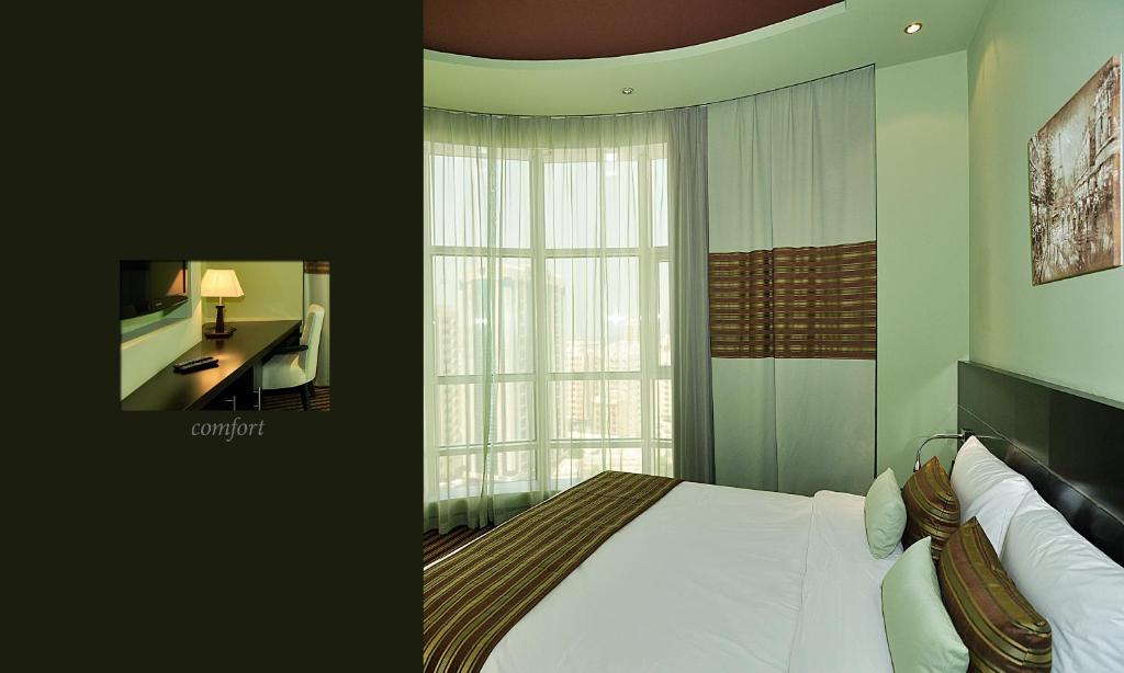 Postel nebo postele na pokoji v ubytování Aldar Hotel