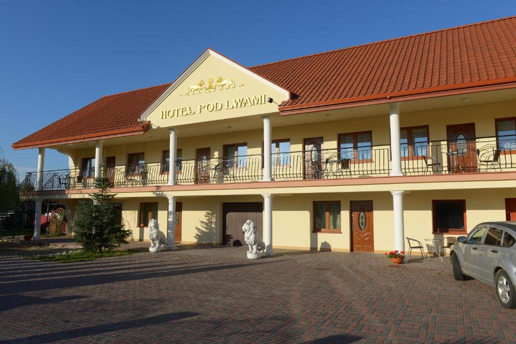 a hotel room with a building with a balcony at Hotelik Pod Lwami in Małaszewicze Duże