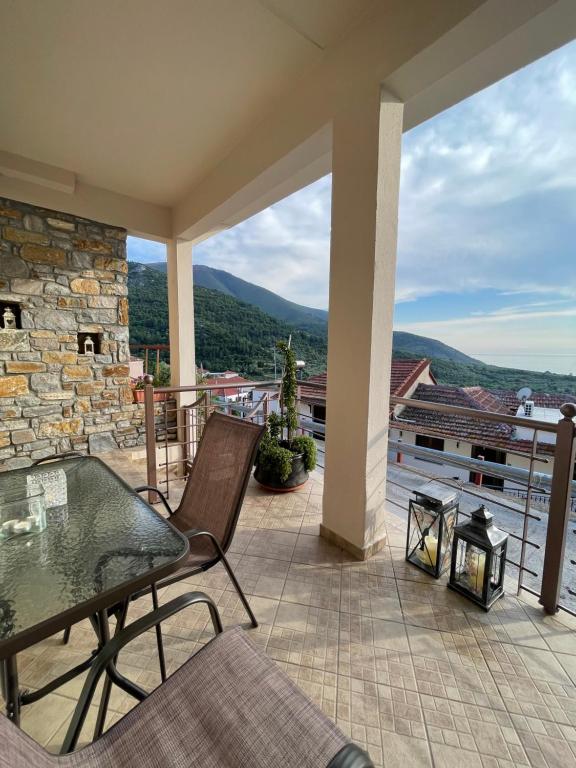 un patio con tavolo e sedie sul balcone. di Ioannis (Family House) a Kallirákhi