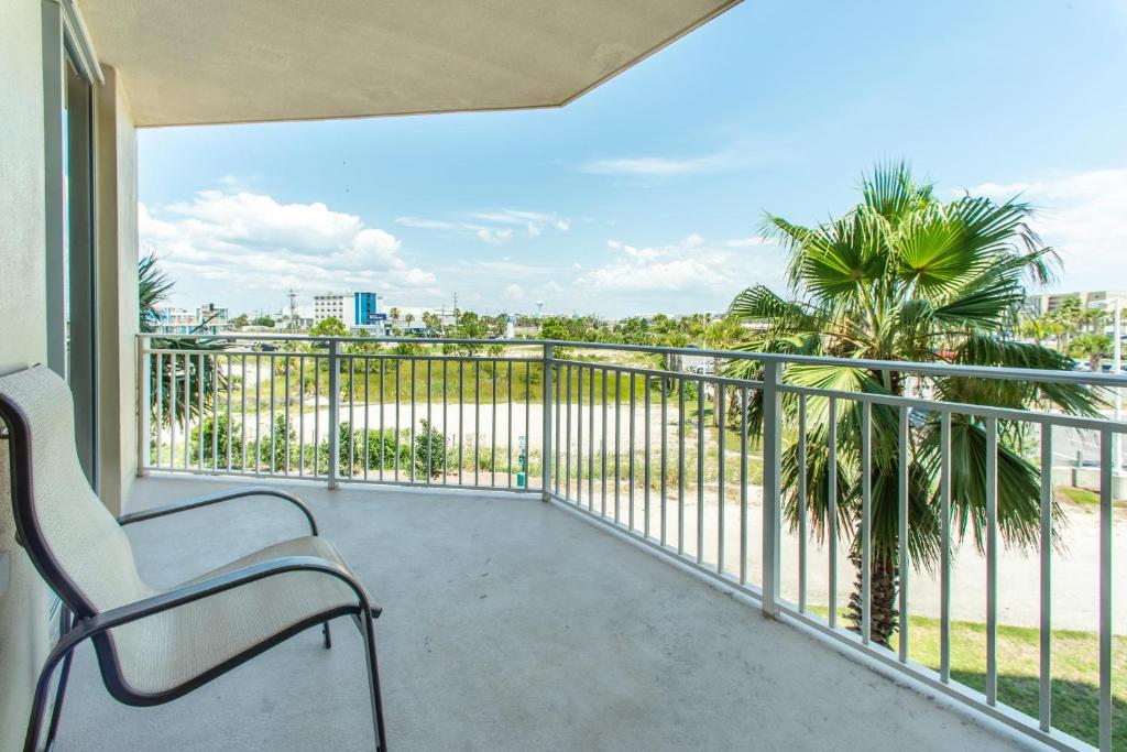 a balcony with a chair and a view of the ocean at Waterscape 235-A in Fort Walton Beach