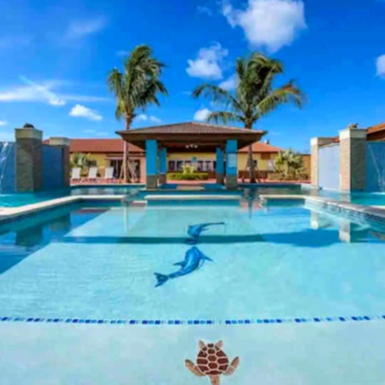 a swimming pool at a resort with a turtle on it at Family Apartment with Pool in Aruba in Palm-Eagle Beach