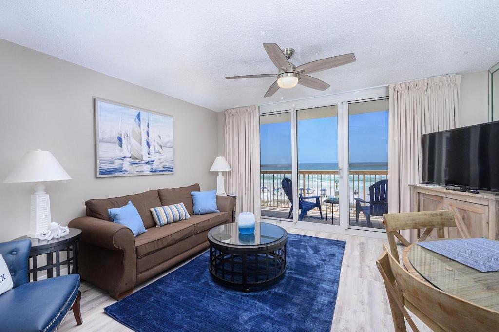 a living room with a couch and a flat screen tv at Pelican Beach Resort 308 in Destin