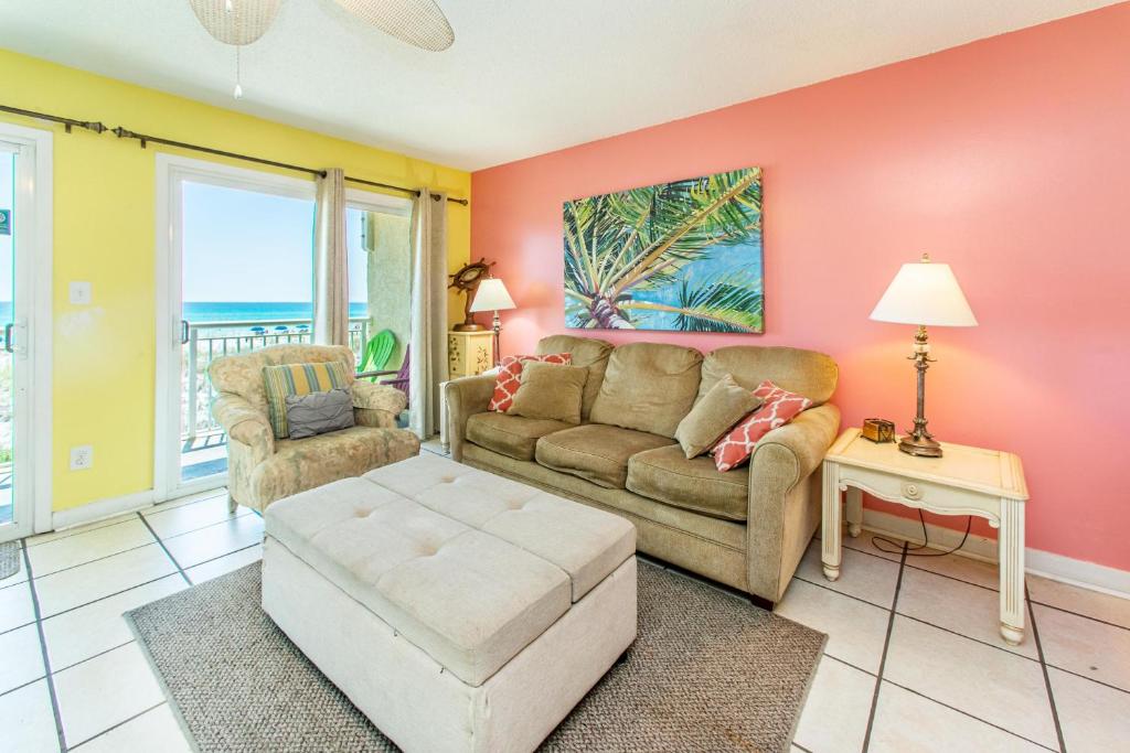 a living room with a couch and a table at Island Sands 206 in Fort Walton Beach
