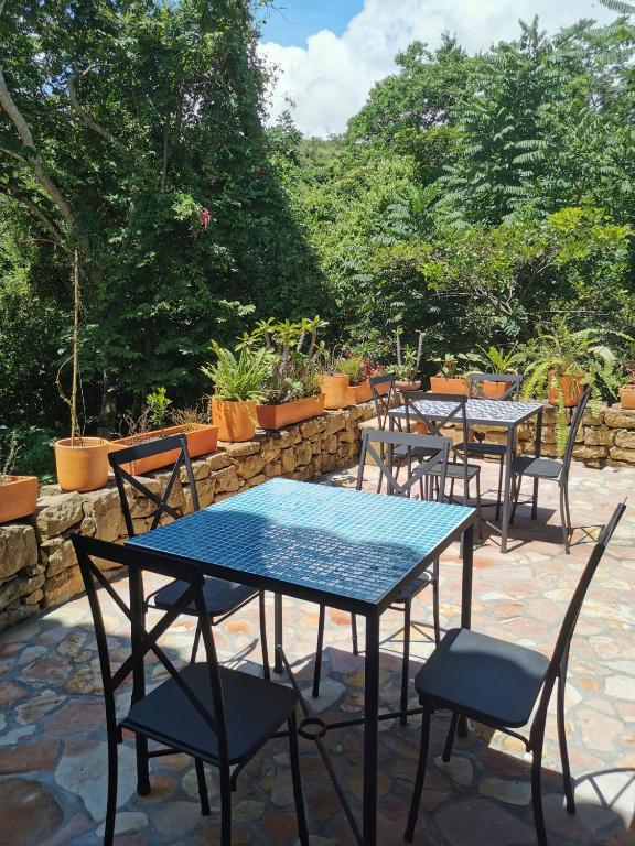 a group of tables and chairs on a patio at Las Cabezas Grises in Barichara