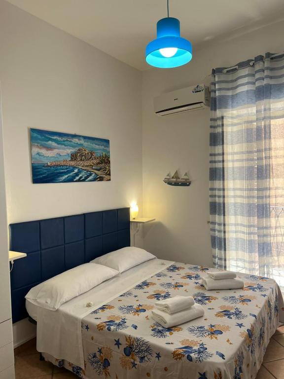 a bedroom with a bed with towels on it at Artista studio in Cefalù
