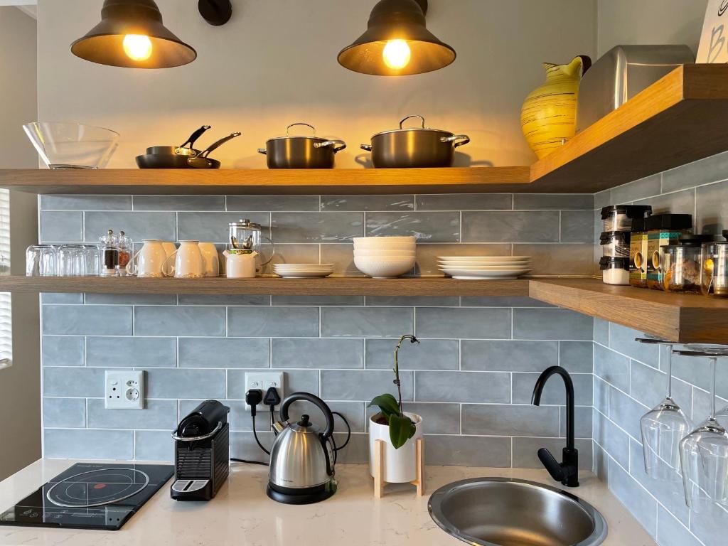 a kitchen counter with pots and pans and a sink at the mod pod studio in Mtunzini