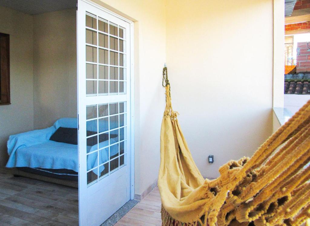 eine Hängematte in einem Zimmer mit einem Schlafzimmer in der Unterkunft Casa com churrasq e Wi-Fi na Praia de Itacuruca RJ in Mangaratiba
