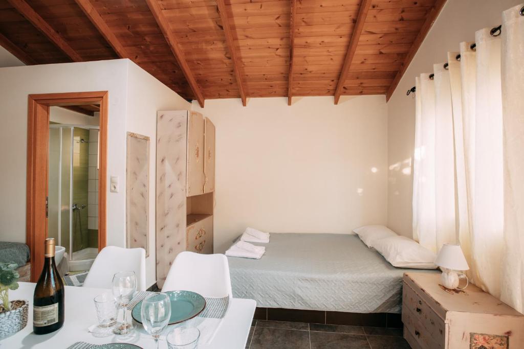 a room with a bed and a table and chairs at Elenis Spiti in Moírai