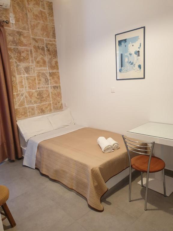 a small room with a bed and a table at ERRIKA in Ermoupoli