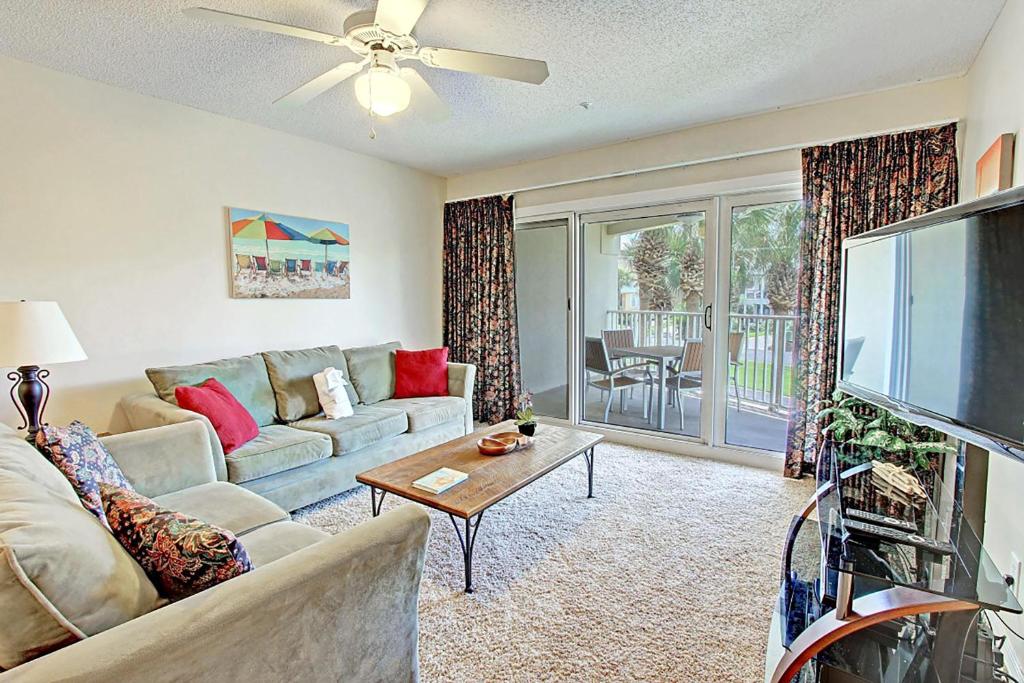 a living room with a couch and a flat screen tv at Maravilla 3202 in Destin