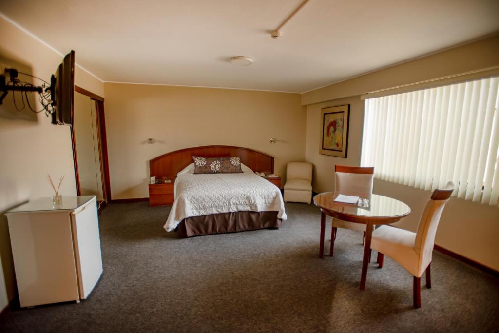 Postel nebo postele na pokoji v ubytování Hotel Park Suites