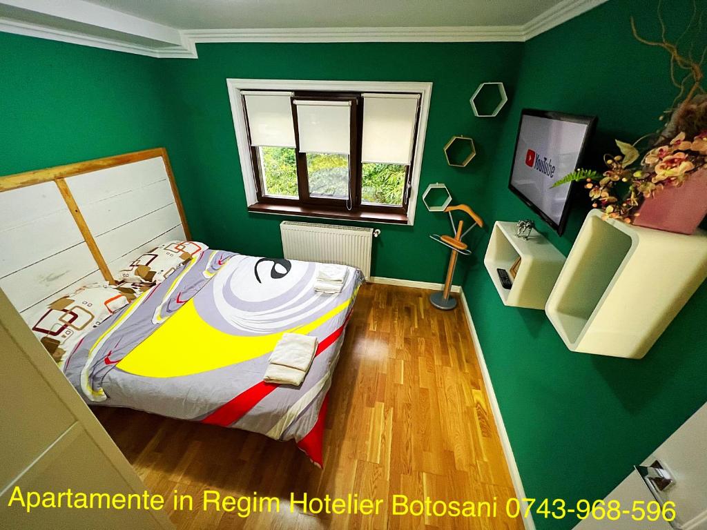 a green bedroom with a bed and a window at Apartament nemaipomenit de frumos Super accesibil in Botoşani