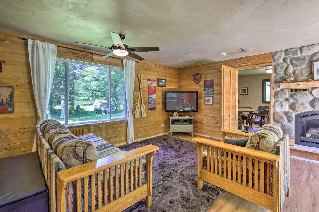a living room with two couches and a tv at Cozy Florence Cabin, Proximity to Keyes Peak! in Florence