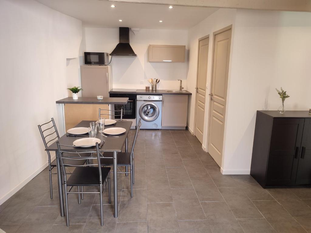 a kitchen and dining room with a table and chairs at Coup de coeur in Ceyreste