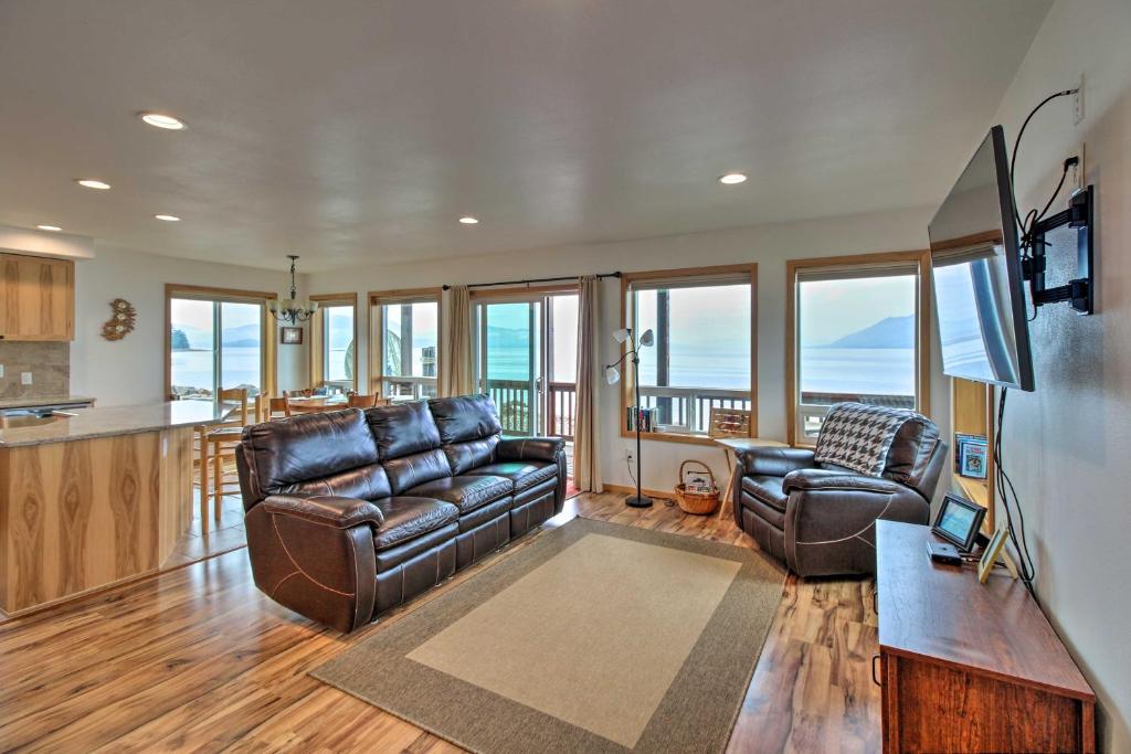 a living room with two leather couches and a kitchen at Oceanfront Craig Apt Grill, Fishing On-Site! in Craig
