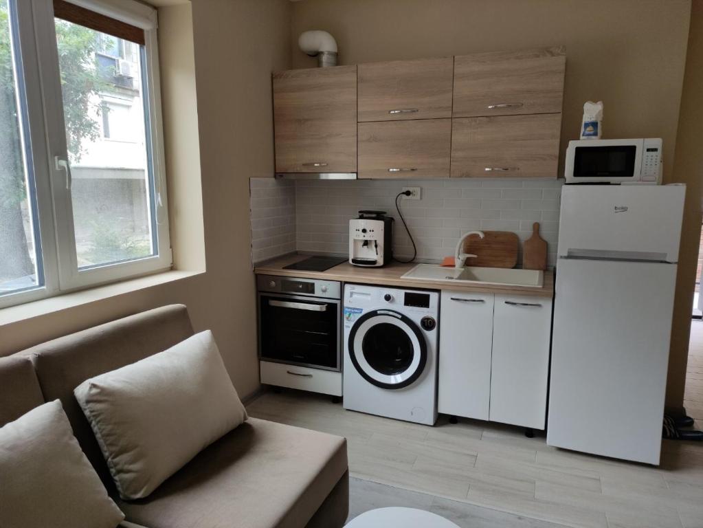 a kitchen with a refrigerator and a washing machine at Light side Inn in Ruse