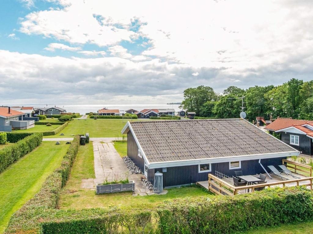 a house with a slate roof and a yard at Two-Bedroom Holiday home in Juelsminde 7 in Sønderby