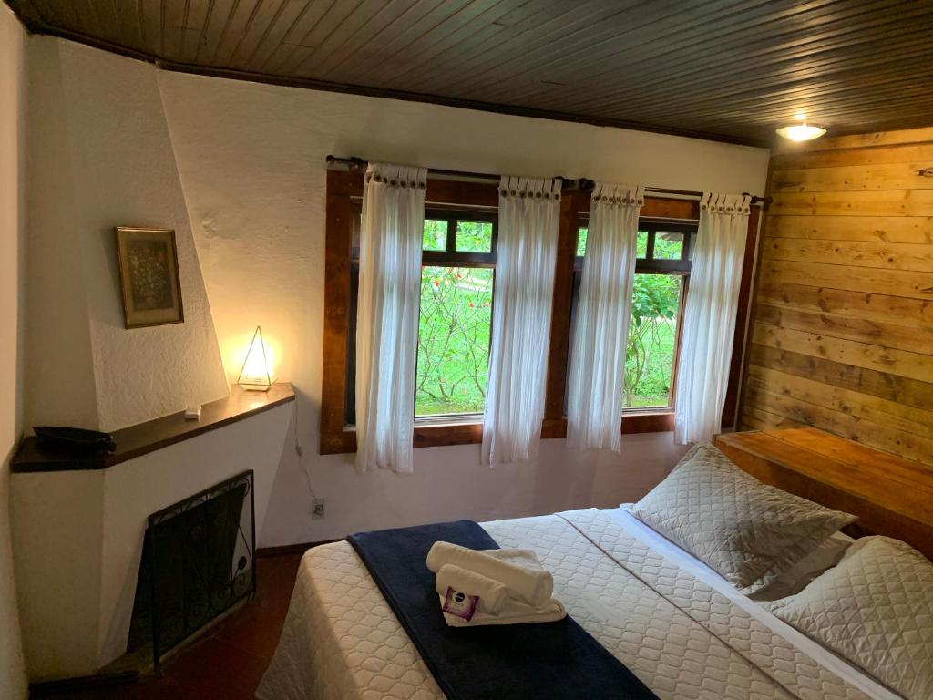 Postel nebo postele na pokoji v ubytování Pousada Sítio Itaúna