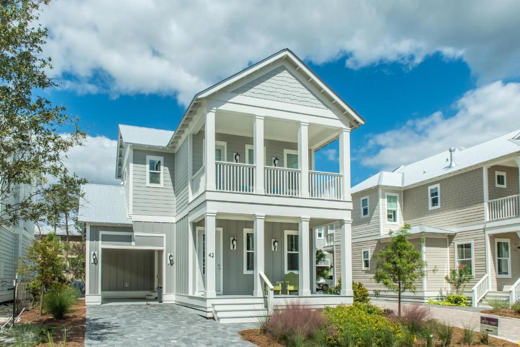 a large white house with a balcony at Grayt Paradise in Grayton Beach