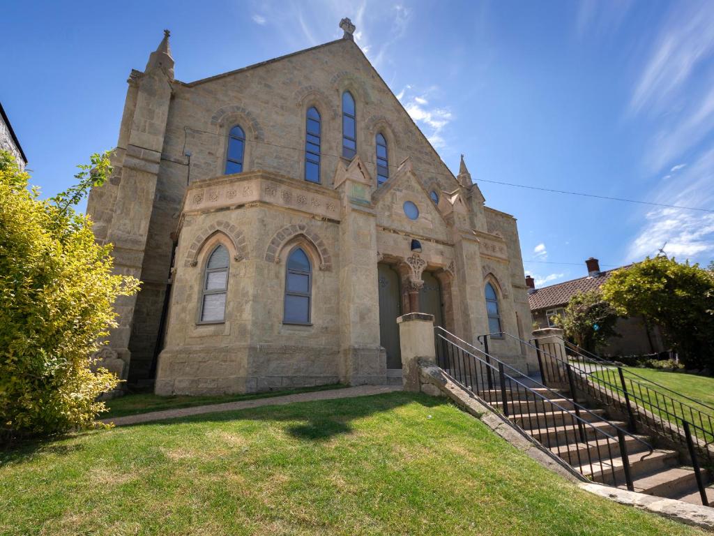 an old stone church with stairs in front of it at No 5 Old Church in Ventnor