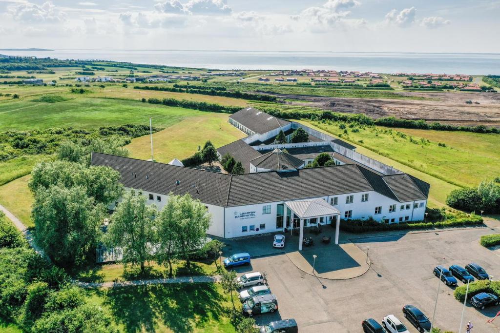 an aerial view of a white building with a parking lot at Løgstør Parkhotel in Løgstør