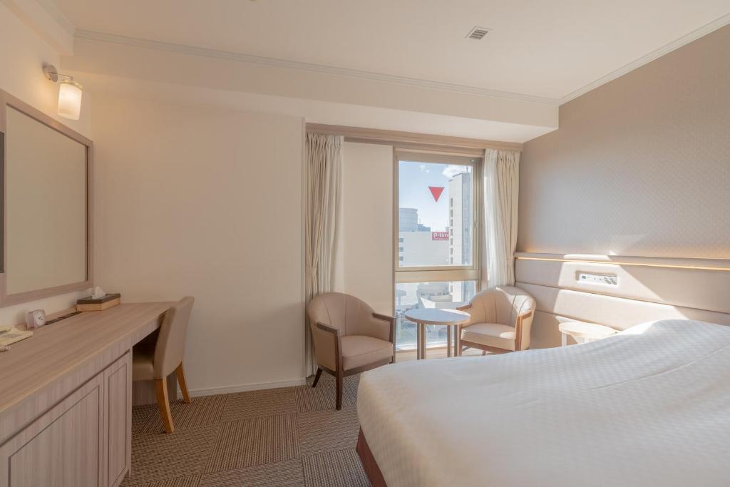 Postel nebo postele na pokoji v ubytování Libre Garden Hotel