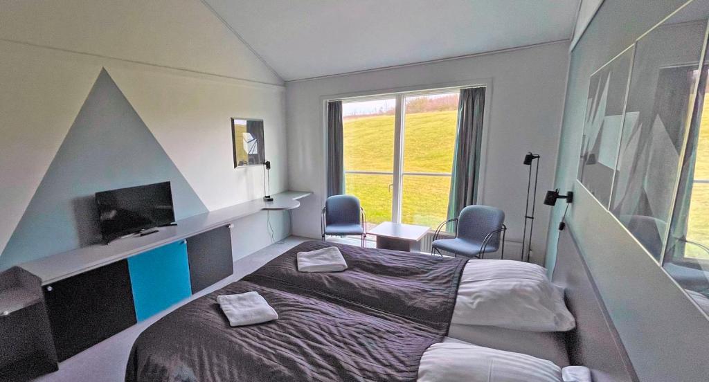 Postel nebo postele na pokoji v ubytování Løgstør Parkhotel