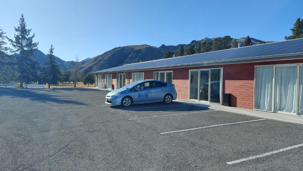 a small blue car parked in front of a building at LAKE ESCAPE - Brand new warm and quiet two bedroom Apartment in Otematata