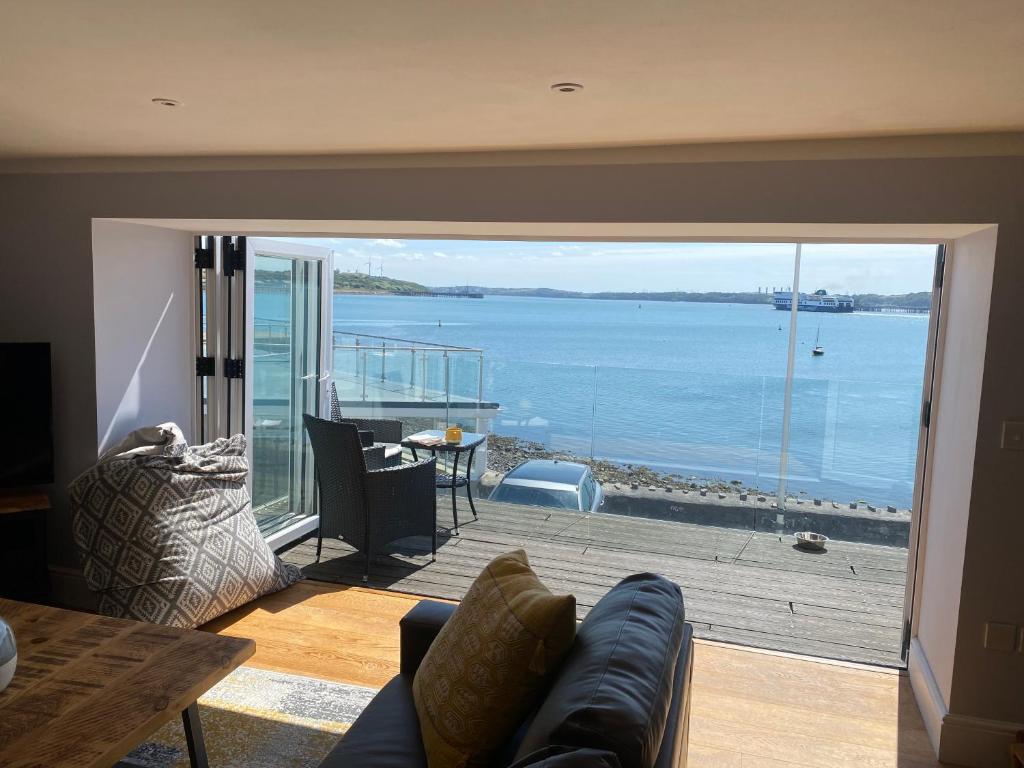 a living room with a view of the ocean at Contemporary living with amazing views. Pembrokeshire in Pembrokeshire