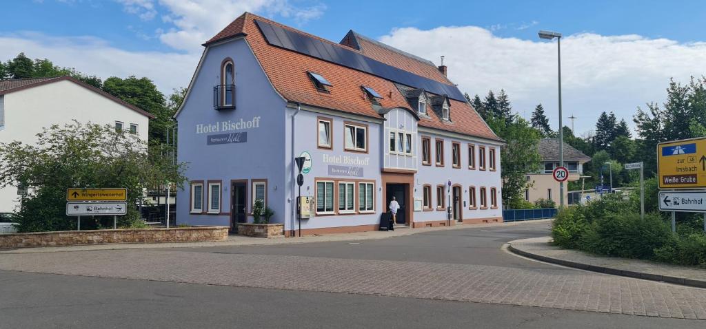 a blue and white building on the side of a street at Hotel Bischoff Winnweiler in Winnweiler