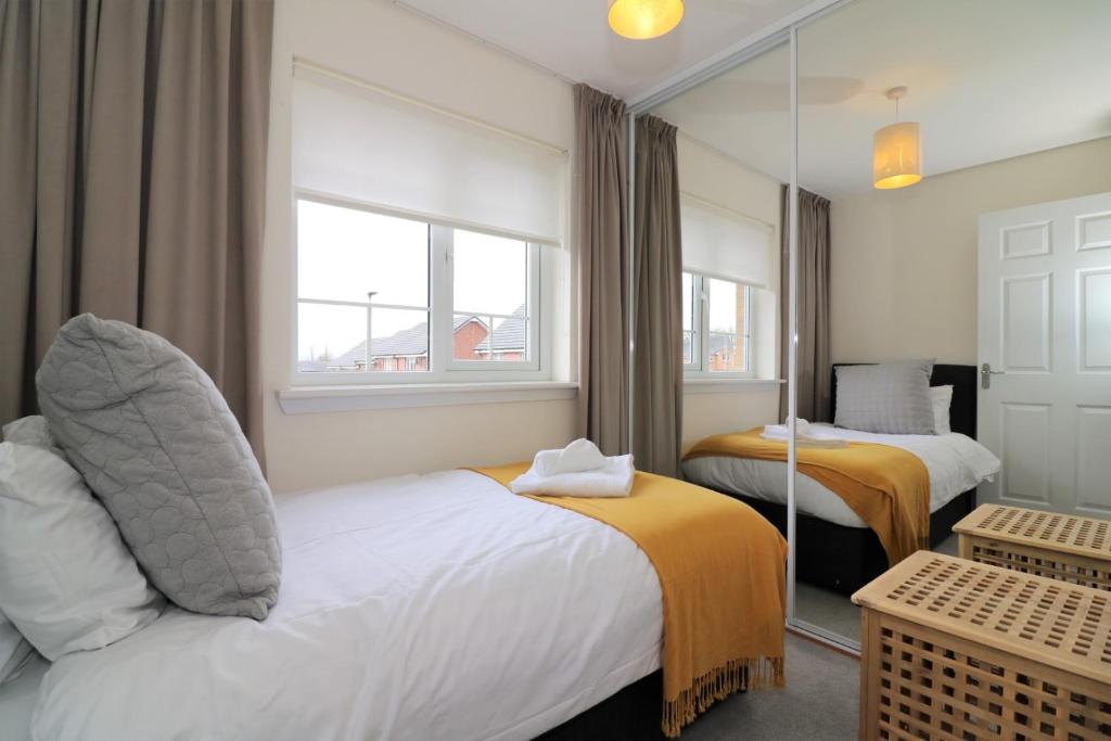 a hotel room with two beds and a window at Signature - Morrison House in Glasgow