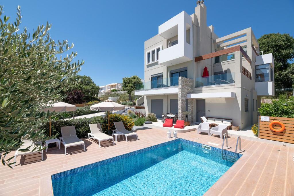 a villa with a swimming pool and a house at Terpsis Pool Villa in Rhodes Town