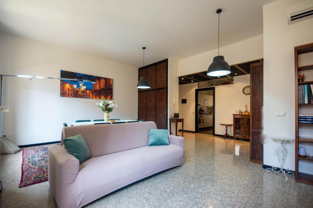 a living room with a white couch at Cattaneo 19 Apartment in Verona