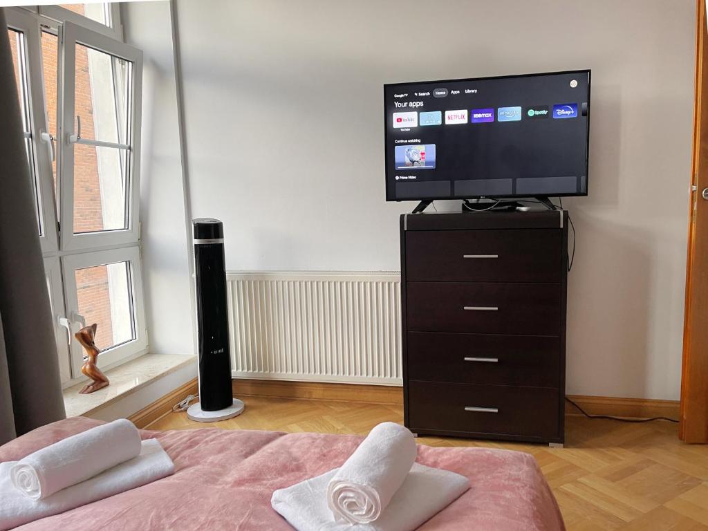 Televízia a/alebo spoločenská miestnosť v ubytovaní Old Town Center - Przy Deptaku