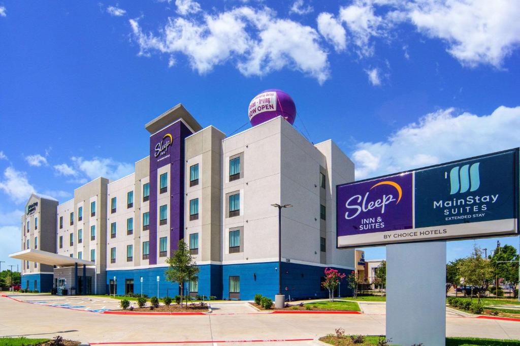a large building with a sign in front of it at Sleep Inn Dallas Northwest - Irving in Dallas
