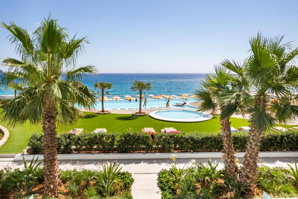 a view of a resort with a pool and the ocean at Konstantinos Palace in Karpathos