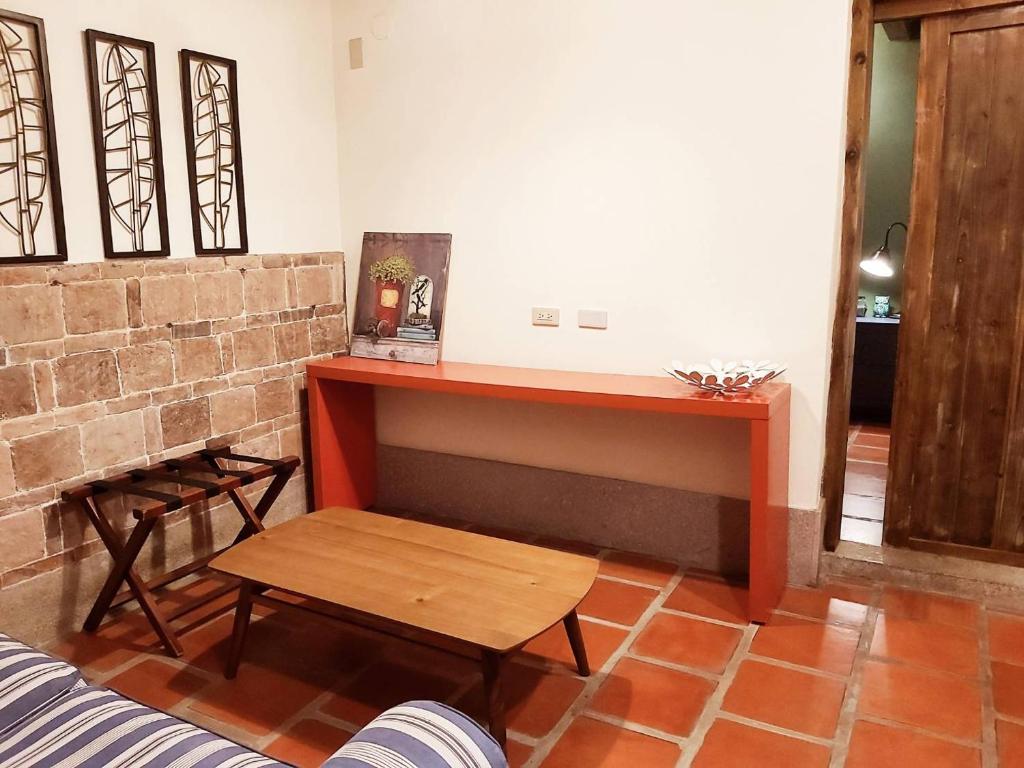 a living room with a table and a bench at Shenten Homestay in Jincheng