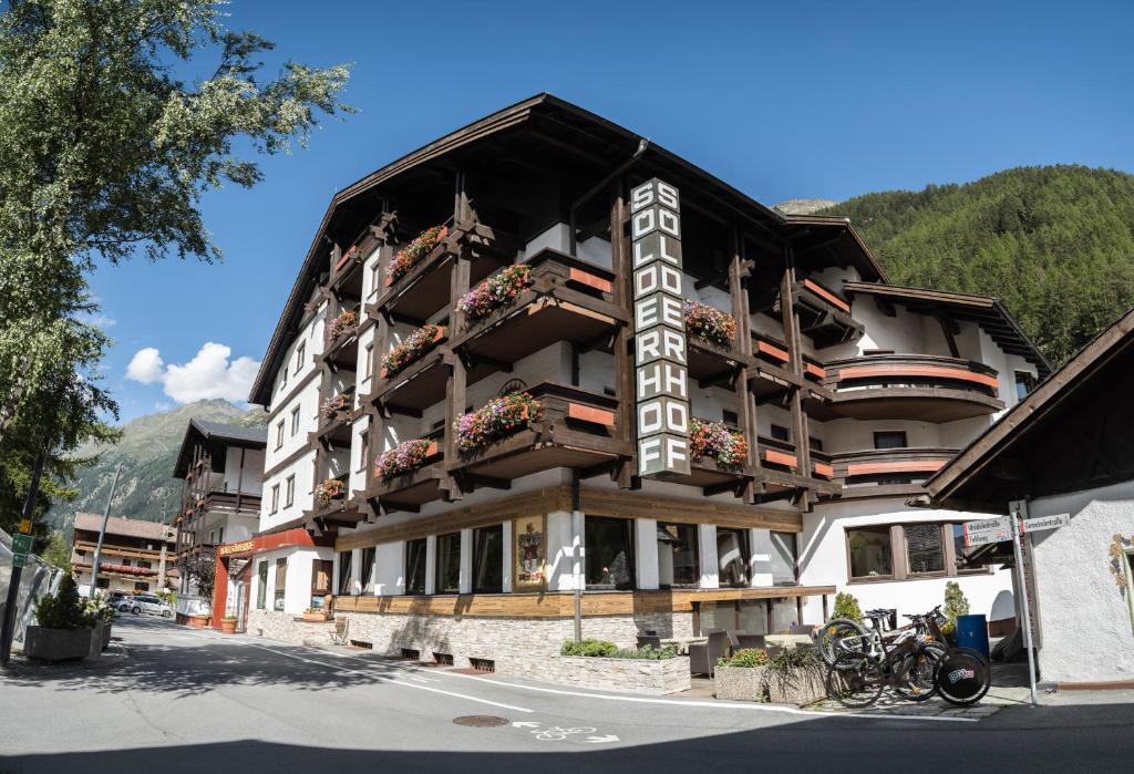 a large building with a sign on the side of it at Hotel Sölderhof in Sölden