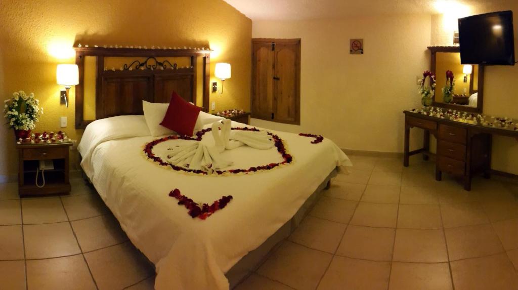 a bedroom with a large bed with a heart made up at Hotel San Jose in San Cristóbal de Las Casas
