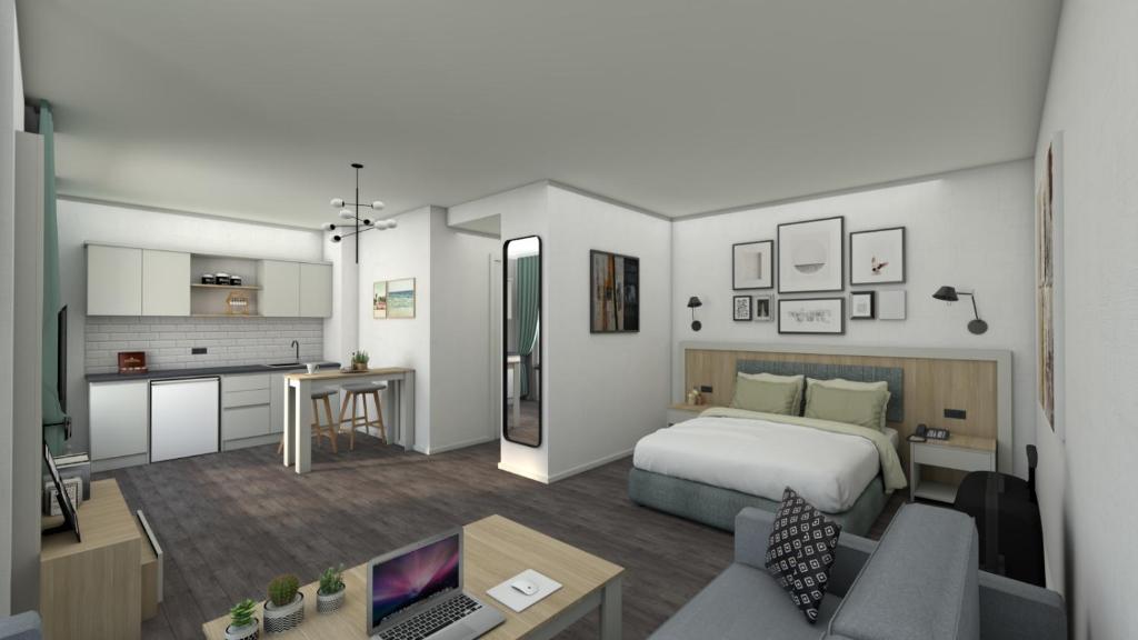 ein Hotelzimmer mit einem Bett und einer Küche in der Unterkunft Weseler Wirtshaus Appartements in Wesel