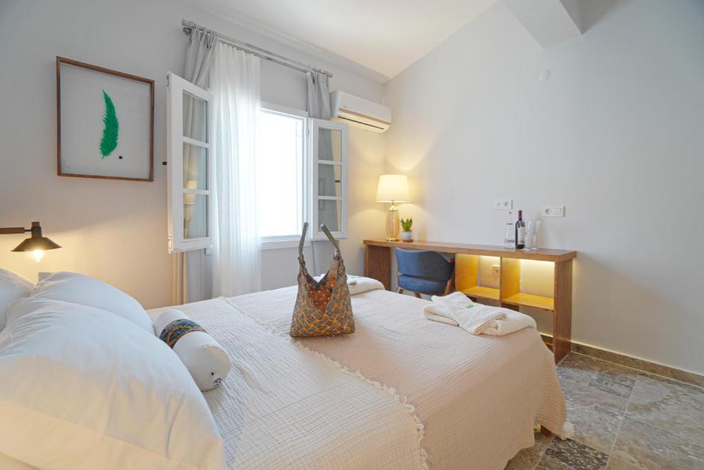 a bedroom with a bed with a purse on it at POM Alaçatı Boutique Otel in Cesme