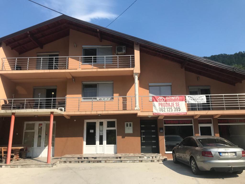 a building with a car parked in front of it at sweet home in Nemila