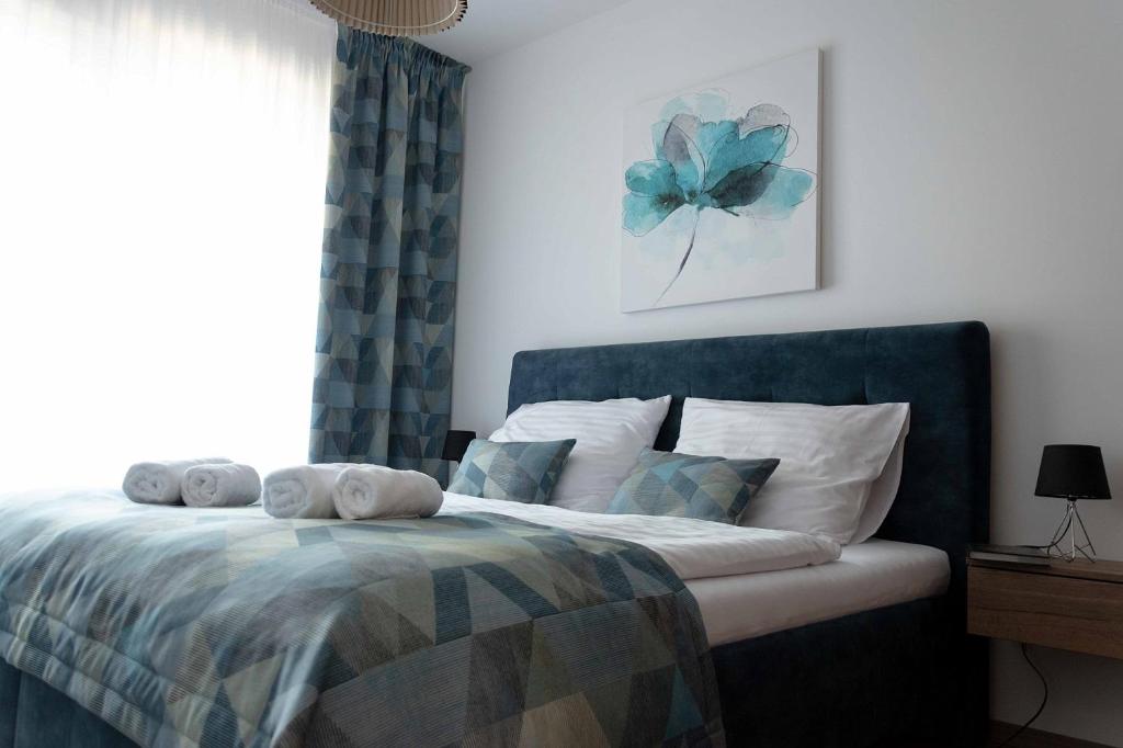 a bedroom with a bed with towels on it at Tabáň Halifax apartment - city center & free parking in Nitra