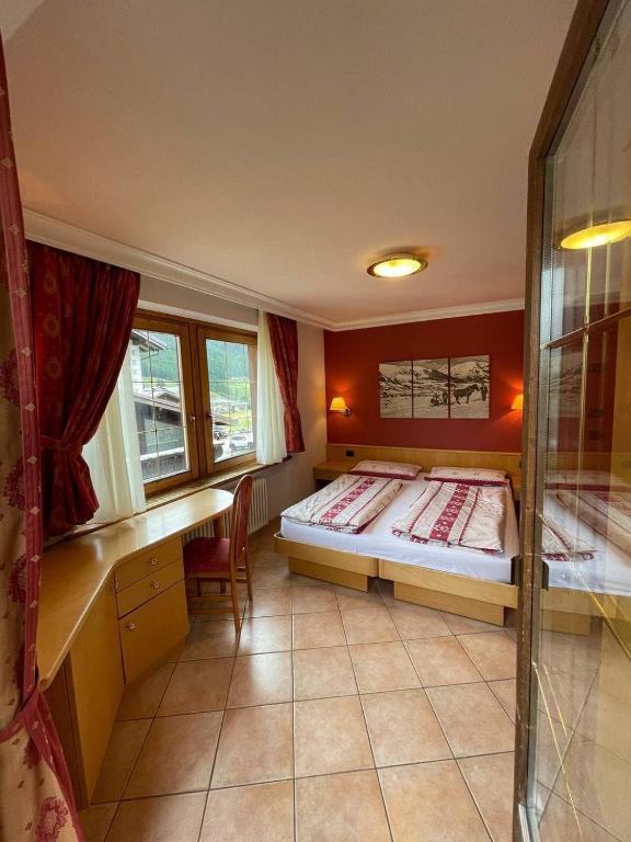 Postel nebo postele na pokoji v ubytování Hotel Garni Rin Da Rin